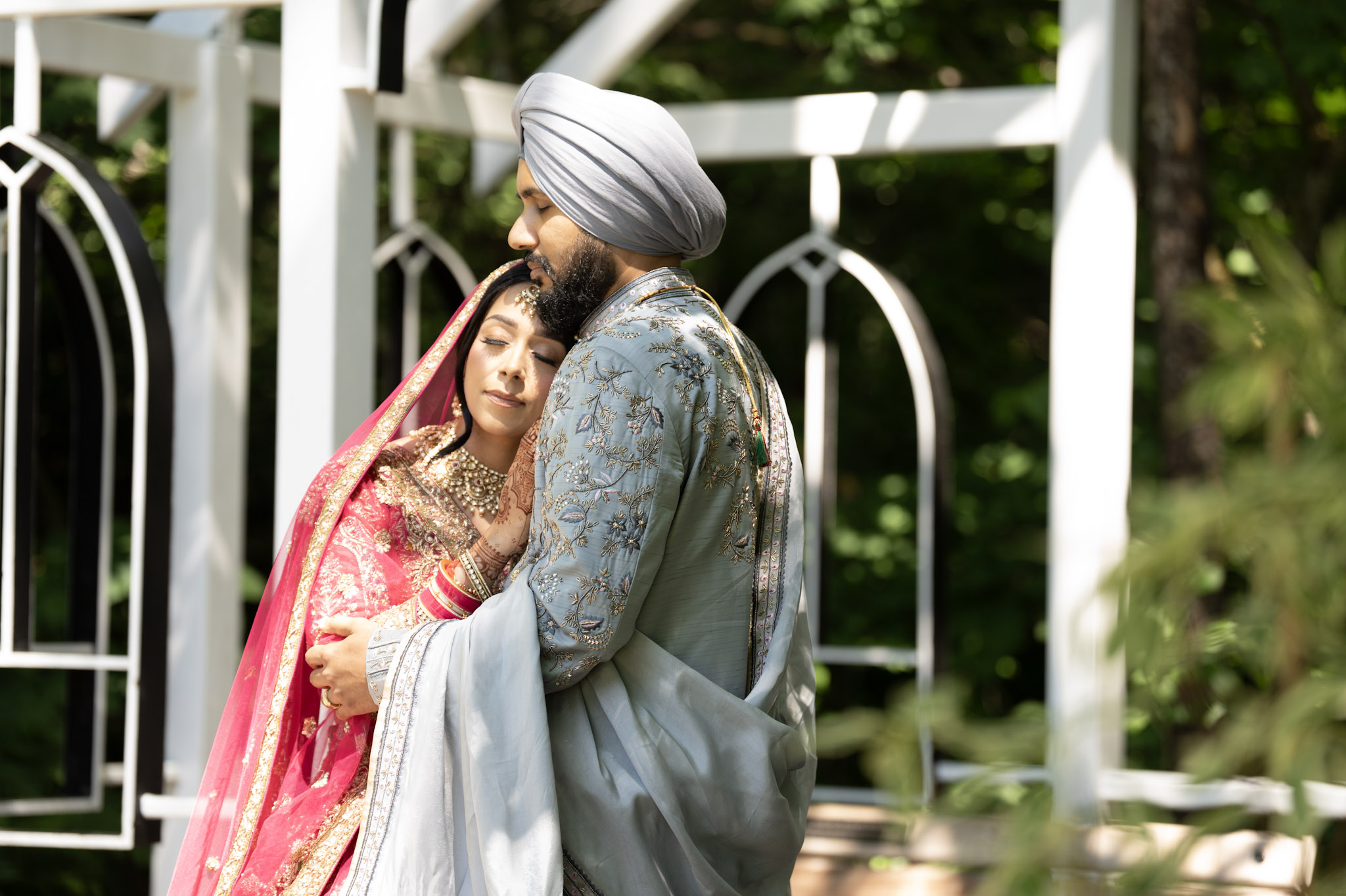 Wedding couple embracing in a garden